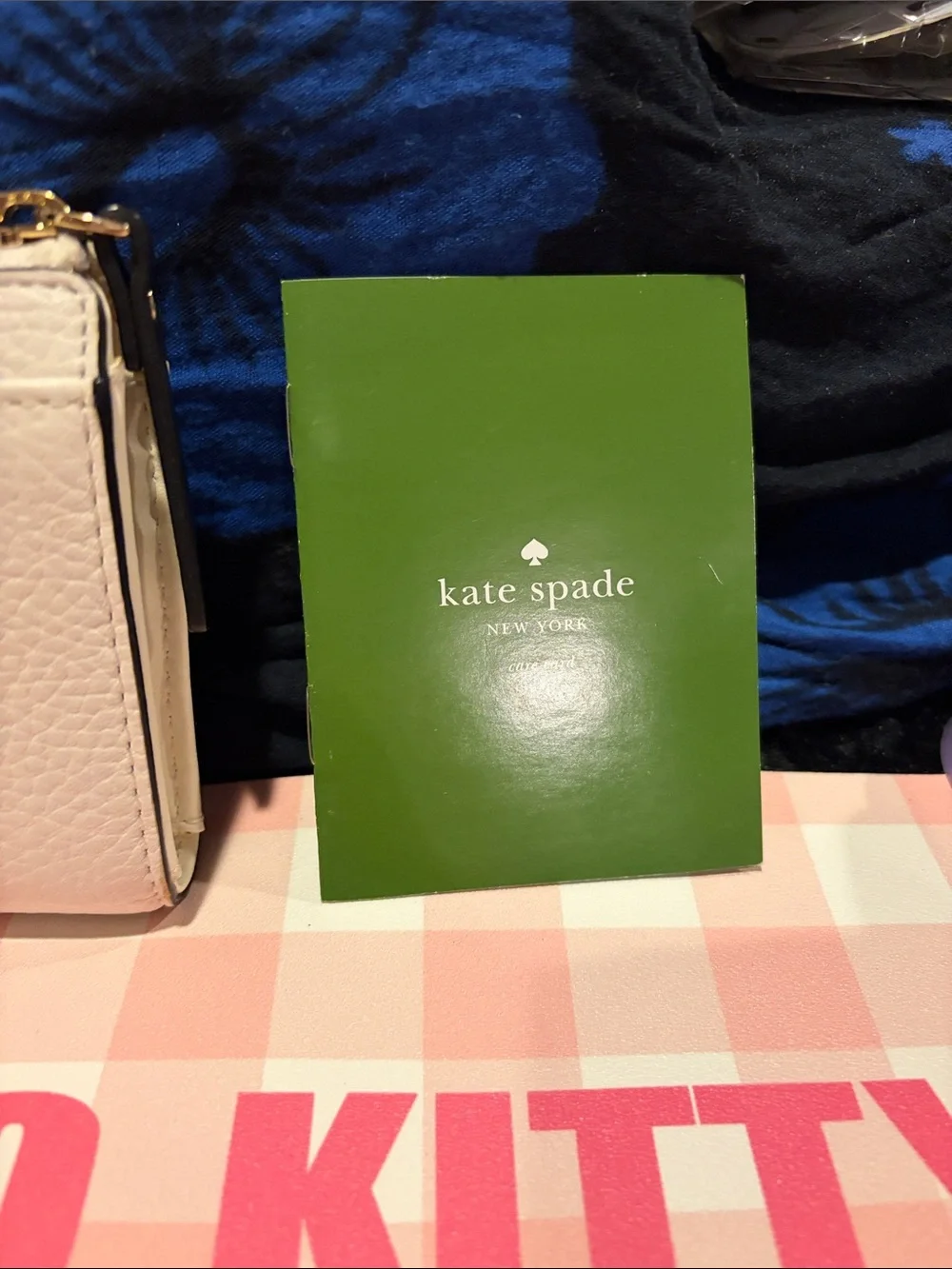 kate spade White Pebbled Leather Zip Wallet with Black Bow and Gold Bar